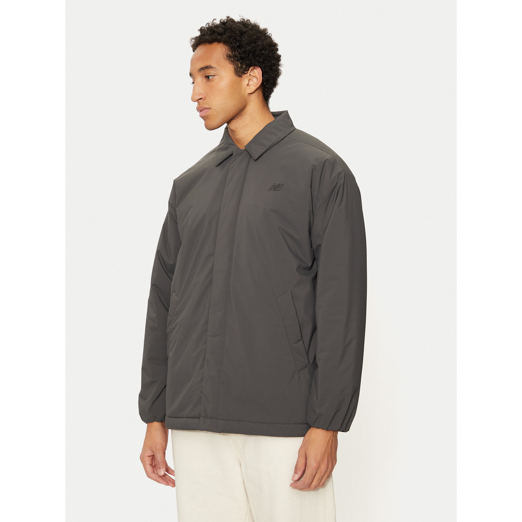 New Balance Übergangsjacke MJ43504 Beige Regular Fit