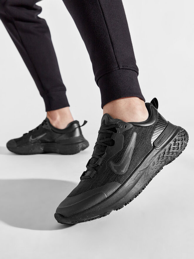 nike running react miler trainers in triple black