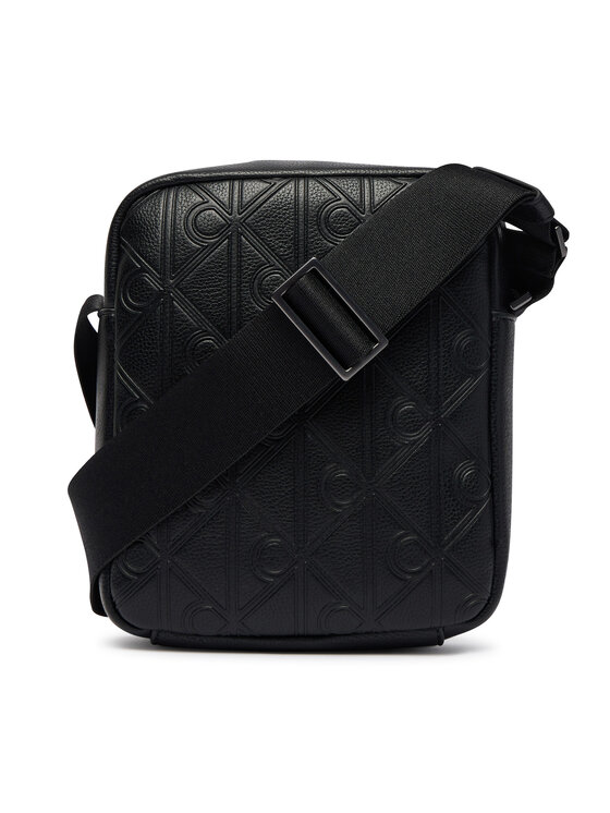 Calvin Klein Taška cez rameno Calvin Klein Emblem Aop Deboss Reporter LV04D3562G Čierna