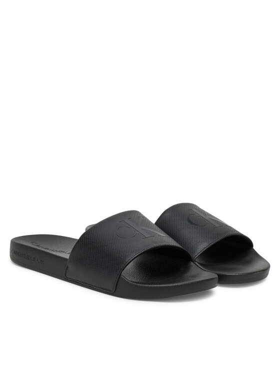 Calvin Klein Jeans Natikači Calvin Klein Jeans Slide Aop Print YM0YM01269 Črna