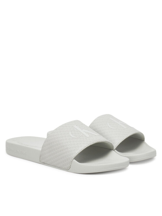 Calvin Klein Jeans Natikači Calvin Klein Jeans Slide Aop Print YM0YM01269 Siva