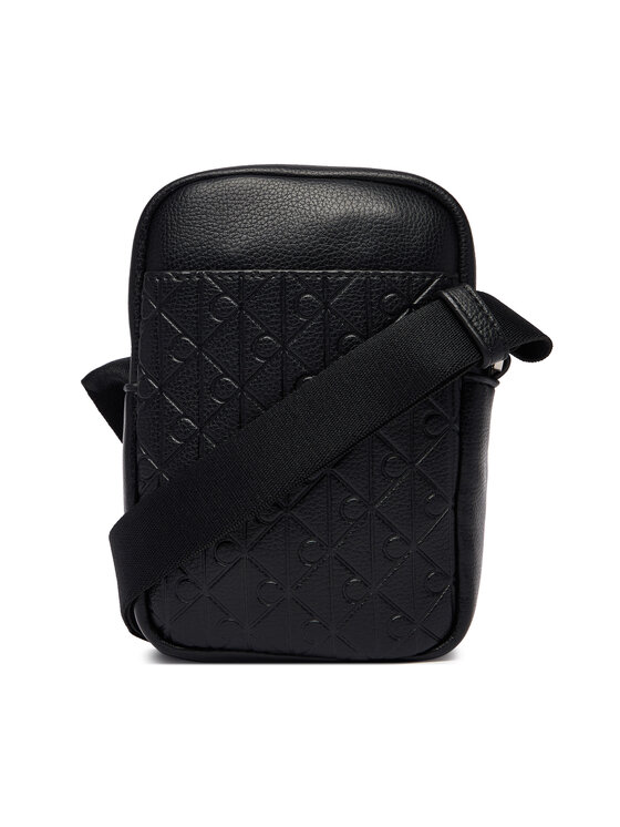 Calvin Klein Taška cez rameno Calvin Klein Emblem Aop Emboss Slim Reporter LV04D3228G Čierna
